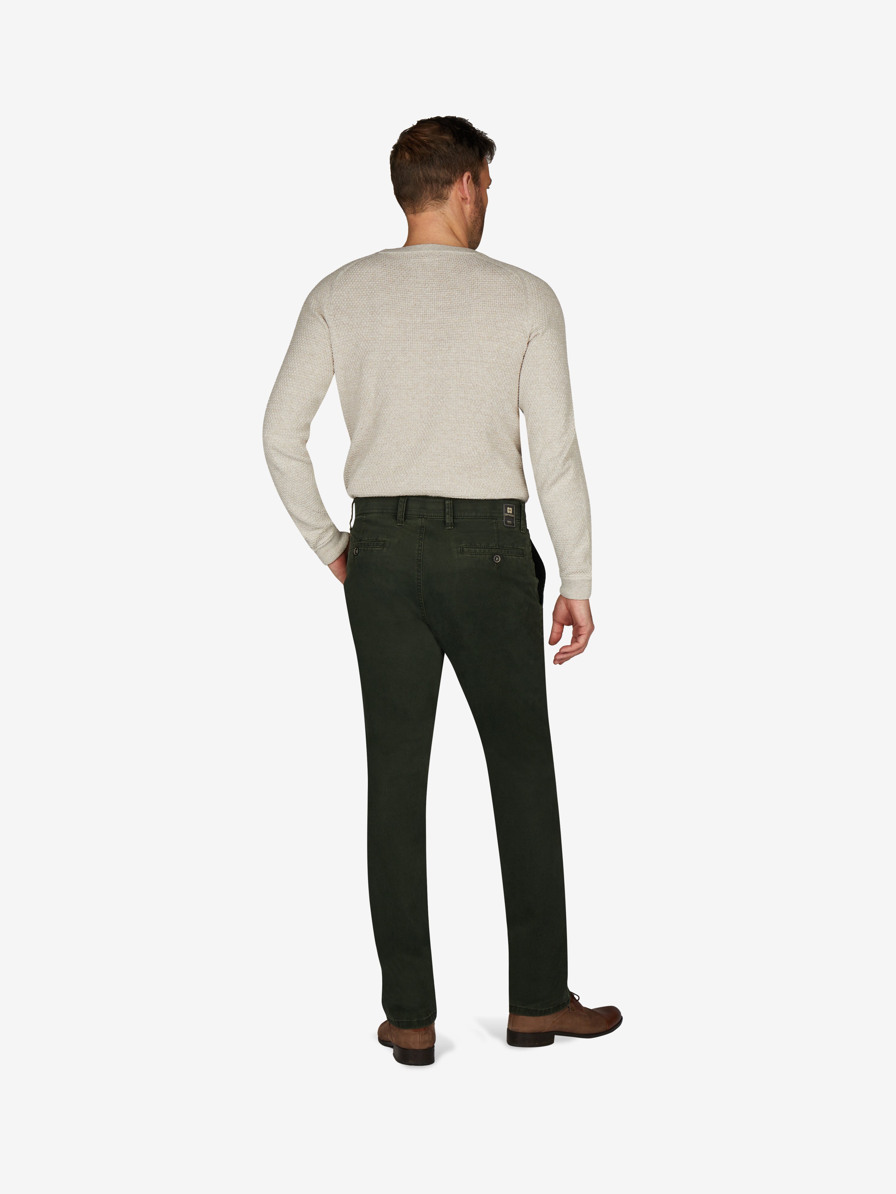 Mann trägt dunkelgrüne GARVEY Flat Front-Hose aus elastischem Baumwoll-Gabardine mit High Stretch, komfortablem Bund und Hemdenstopper, normaler Leibhöhe, schmalerer Fußweite und edlem Griff, ideal für Herbst/Winter.